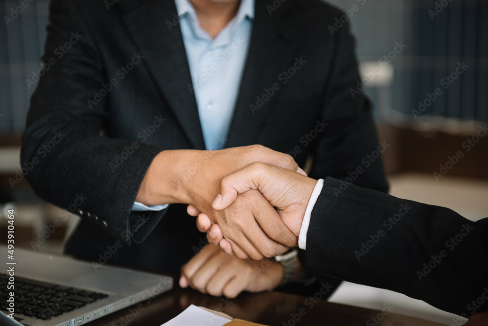Business men and women shake hands confidently professional investor working with new startup project at an office meeting. Business men and women shake hands confidently professional investor working with new startup project at an office meeting.