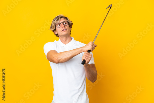 English man over isolated white background playing golf