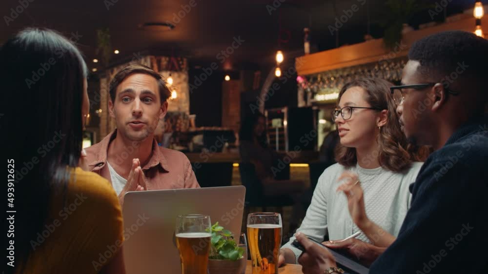 diverse group of work colleagues gathered in restaurant for meeting discussing the future
