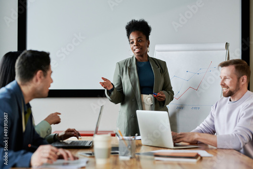 Businesswoman asking doubt to colleague in meeting at office photo