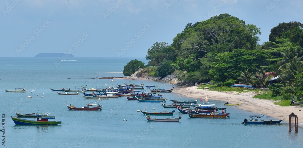 Traditional fishing boats near a small beach village in Langkawi, Malaysia