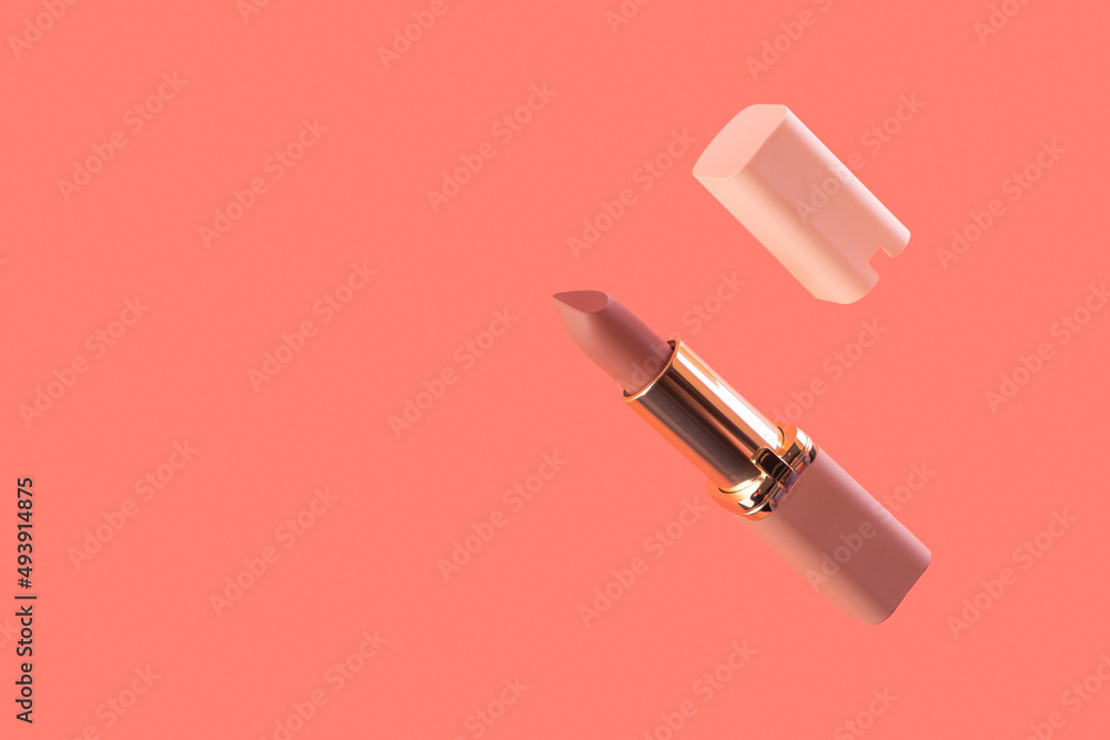 Levitation nude matte lipstick and cap on a pink background in a pink and gold tube top view. Professional cosmetic product for the work of a makeup artist flat lay. Bright backdrop with copy space. Levitation nude matte lipstick and cap on a pink background in a pink and gold tube top view. Professional cosmetic product for the work of a makeup artist flat lay. Bright backdrop with copy space.