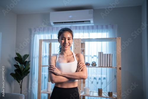 Portrait of Asian active young girl in sportswear stand crossing arms. 