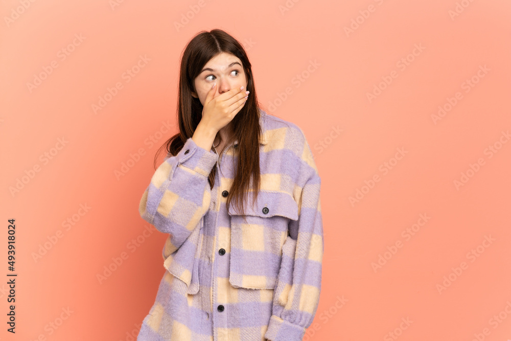 Young Ukrainian girl isolated on pink background doing surprise gesture while looking to the side Young Ukrainian girl isolated on pink background doing surprise gesture while looking to the side