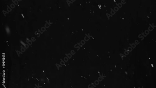 Natural real snow footage on black background isolated, using for overlay effect. photo