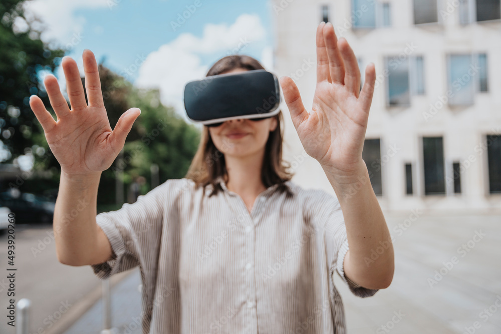 Woman gesturing wearing virtual reality headset at street Woman gesturing wearing virtual reality headset at street