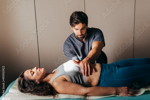Physiotherapist doing visceral manipulation to a woman
