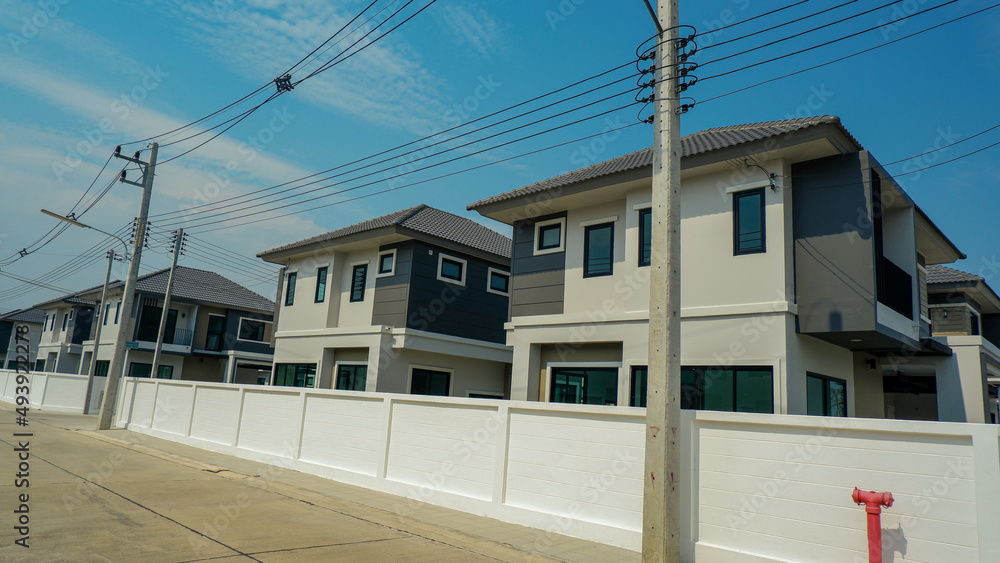 The background wall is lined with housing estates and electric poles run along the sides of the wall. The background wall is lined with housing estates and electric poles run along the sides of the wall.