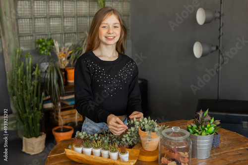 attractive girl doing floristry indoors 