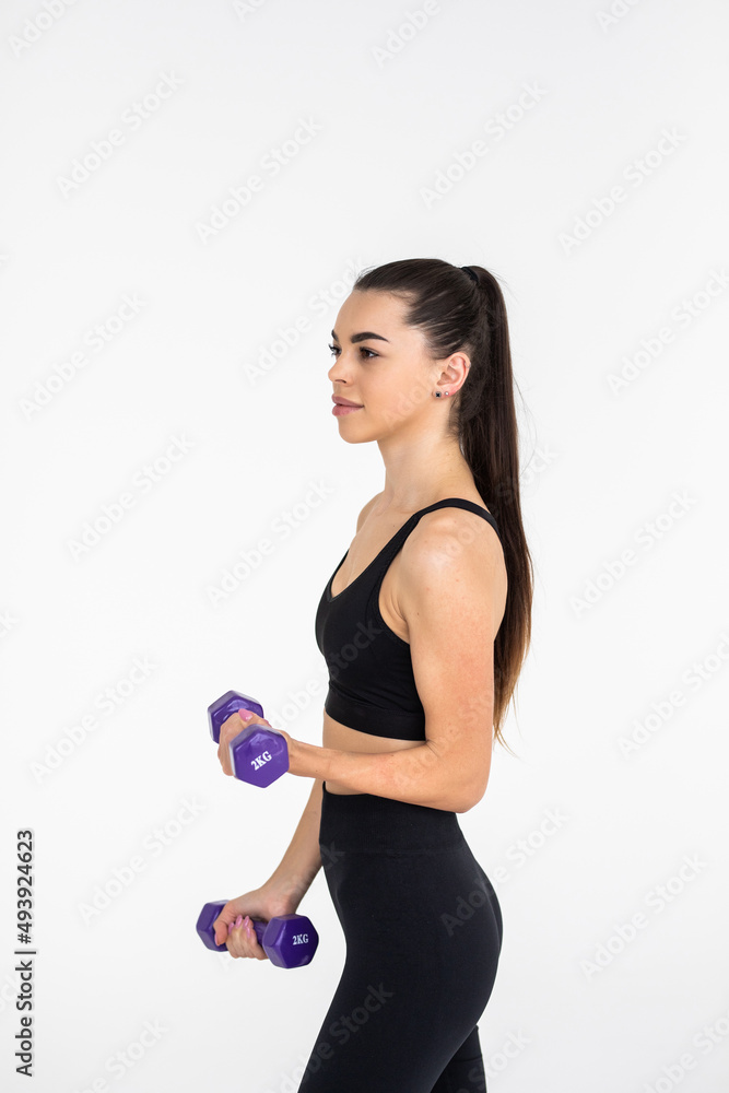 Young woman with dumbbell fit slim abs body isolated on a white background. Healthy lifestyle. Young woman with dumbbell fit slim abs body isolated on a white background. Healthy lifestyle.