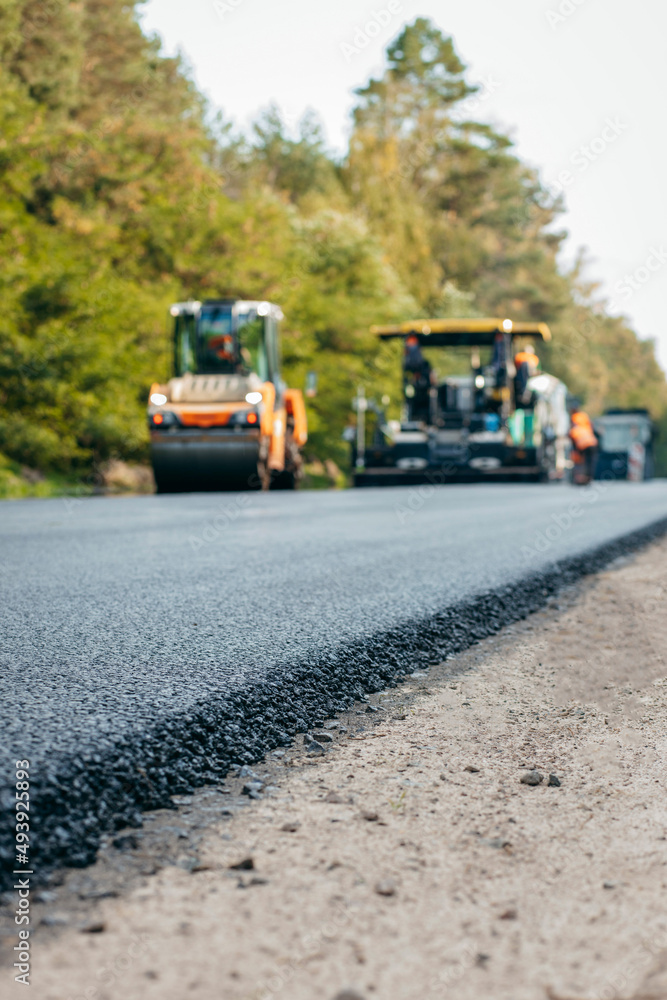 Vibratory asphalt rollers compactor compacting new asphalt pavement. Road service repairs the highway Vibratory asphalt rollers compactor compacting new asphalt pavement. Road service repairs the highway