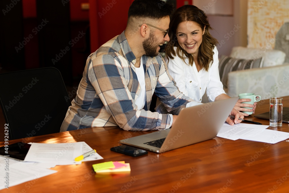 Colleagues drinking coffee in office. Businesswoman and businessman discussing work in office. Colleagues drinking coffee in office. Businesswoman and businessman discussing work in office.