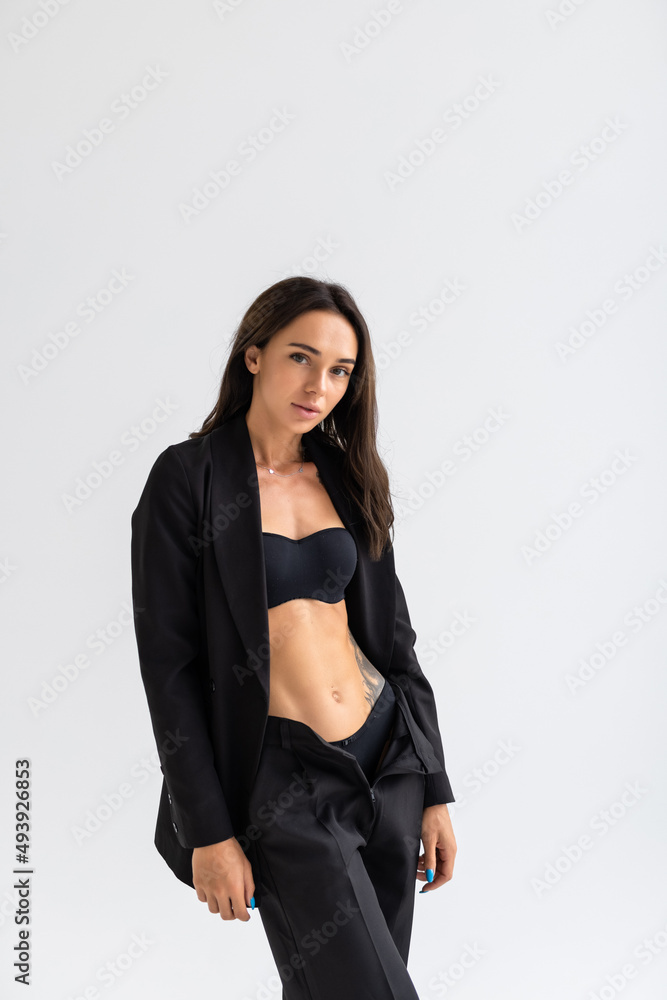 Sexy slim woman wearing black bra fashionable with holding suit isolated on white background. Sexy slim woman wearing black bra fashionable with holding suit isolated on white background.