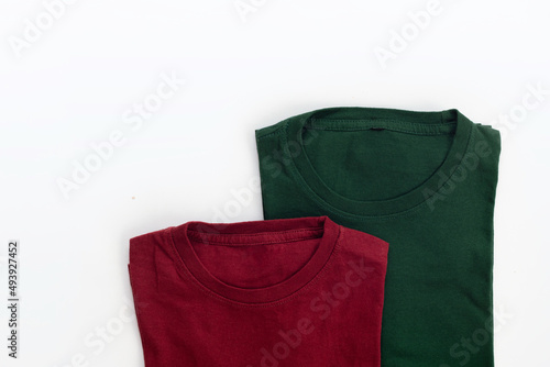 Close up shot of folded dark red and green t-shirt with white background