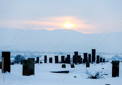Historical Ahlat Seljuk Square Cemetery with islamic tombstones during winter under snow