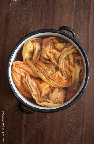 slow fashion concept - hand dying with natural colors -  hand dyed silk scarf in a pot