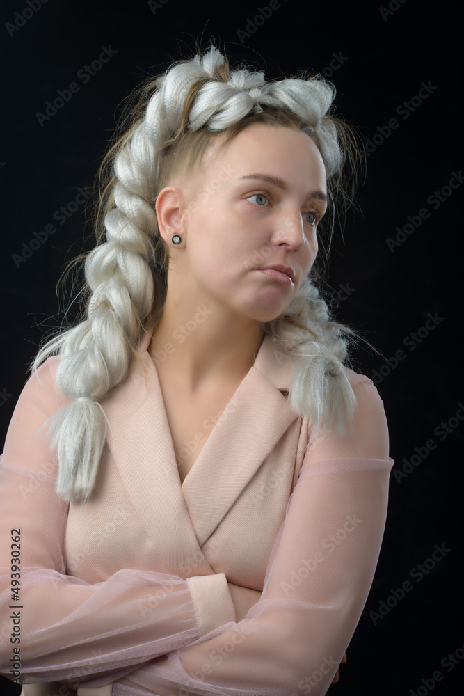 portrait of beautiful pensive young blonde woman on dark background