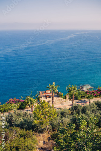 A view of the Mediterranean coast with waves of azure water. Summer seascape. Seaside in sunny weather. Beautiful sea view