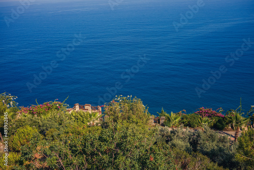 A view of the Mediterranean coast with waves of azure water. Summer seascape. Seaside in sunny weather. Beautiful sea view