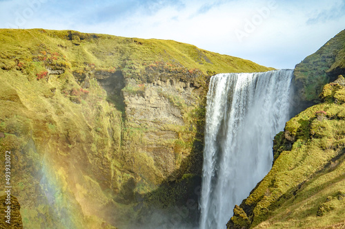 Skógafoss Waterfall with a rainbow forming in the spray