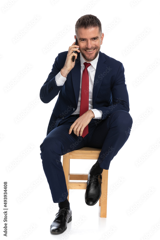 attractive man in his forties having a conversation on the phone attractive man in his forties having a conversation on the phone