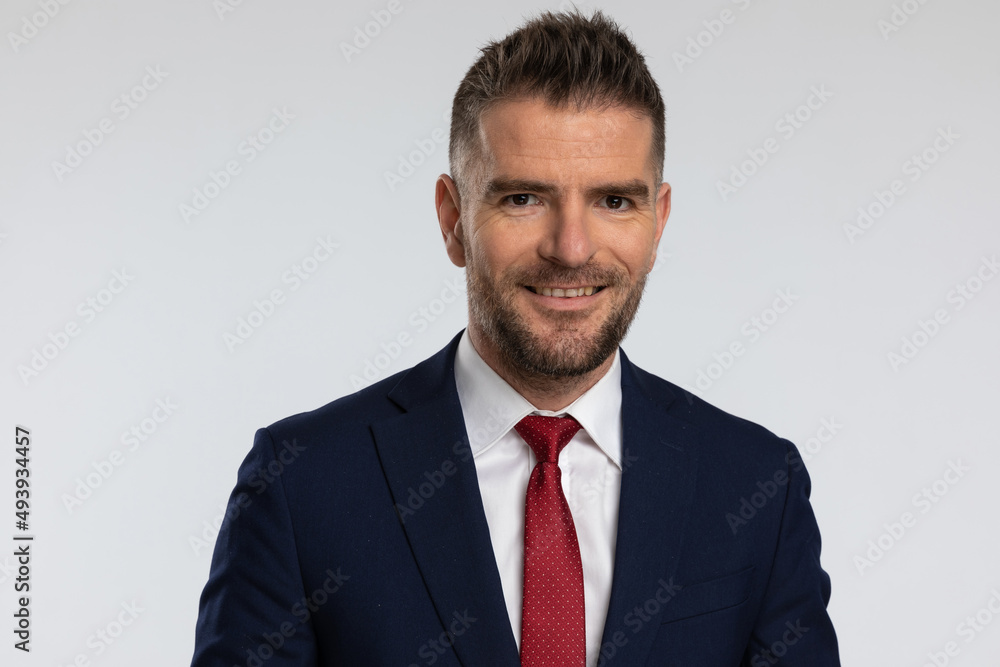 portrait of attractive middle aged businessman in elegant suit smiling portrait of attractive middle aged businessman in elegant suit smiling