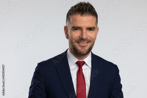 portrait of attractive middle aged businessman in elegant suit smiling