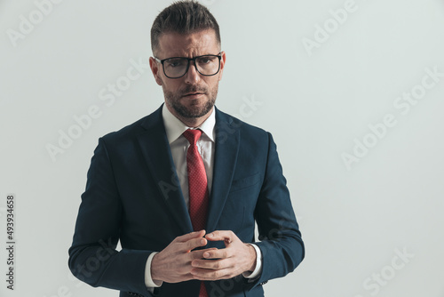 elegant businessman with beard and glasses scowling © Viorel Sima
