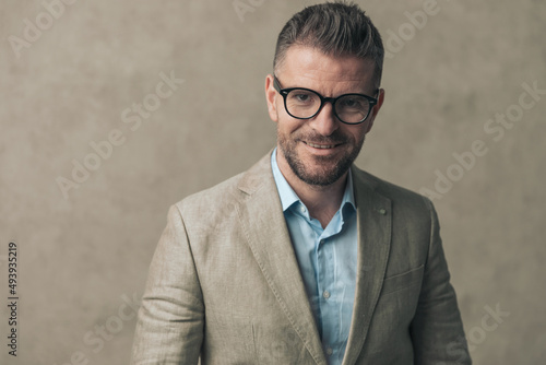 attractive businessman with cute smile is wearing eyeglasses