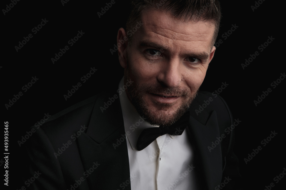 portrait of attractive groom in black tuxedo being happy portrait of attractive groom in black tuxedo being happy