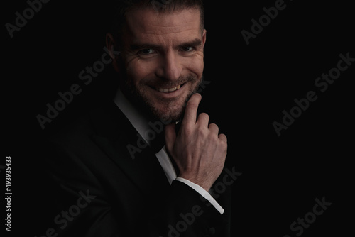 close up of attractive businessman touching beard and smiling © Viorel Sima
