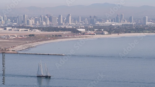 San Diego city skyline, cityscape of downtown with highrise skyscrapers, California coast, USA. View of Coronado island from above, Point Loma vista viewpoint. Frigate sail-powered ship, windjammer. photo