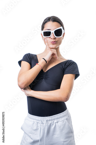 Studio portrait of young brunette model woman wearing funny fancy white sun glasses making faces
