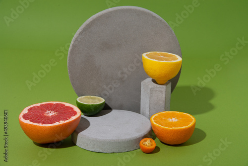 set of citrus fruits on concrete shapes with copy space