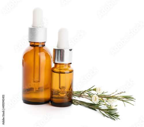 Bottles of natural essential oil on white background