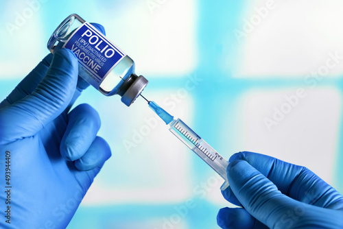 Doctor with vial of the doses vaccine and syringe for Polio IPV Inactivated poliomyelitis Virus. Vaccination and health care concept. Vaccination for booster shot for Polio IPV Inactivated poliomyelit photo