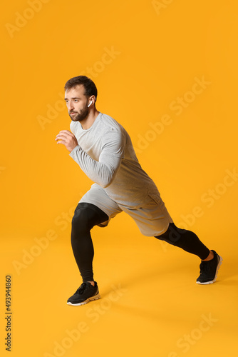 Sporty male runner on color...