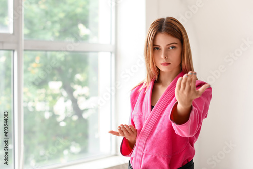 Free Download Young woman practicing karate in gym - GFXLoad