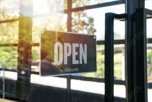 Open sign hanging front of cafe or restaurant. Sign with wording Welcome customer. Business service and food concept.