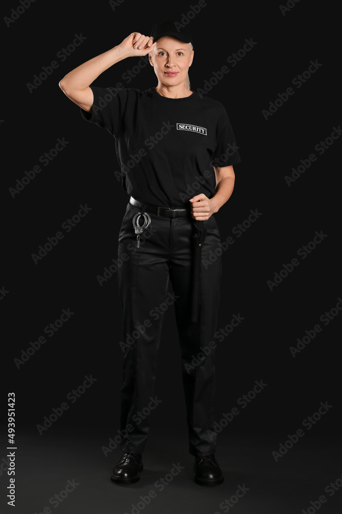 Female security guard on dark background
