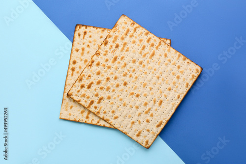 Jewish flatbread matza for Passover on blue background photo