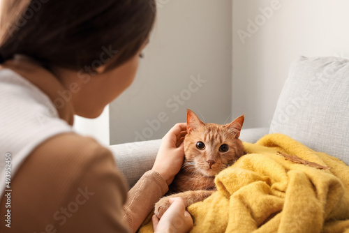 Woman with cute ginger cat ...