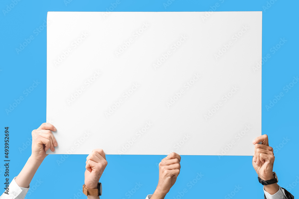 Business men with blank paper sheet on blue background Business men with blank paper sheet on blue background