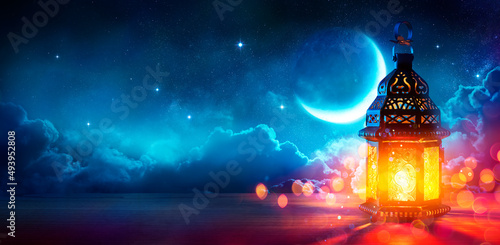 Ramadan Kareem - Moon And Arabian Lantern With Blue Sky At Night With Abstract Defocused Lights - Eid Ul Fitr photo
