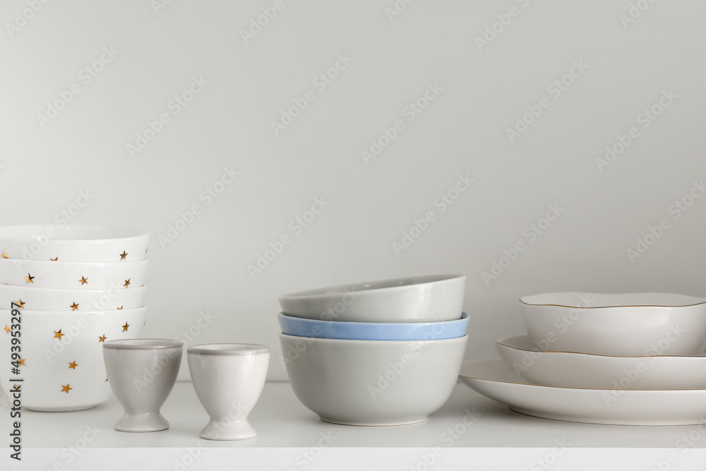 Shelf with set of clean dishes in kitchen Shelf with set of clean dishes in kitchen