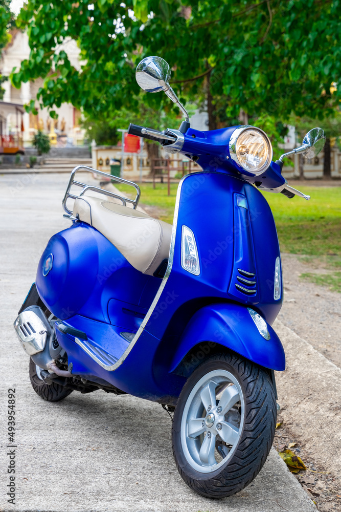 Blue Motor bike at temple in Phuket town thailand. 