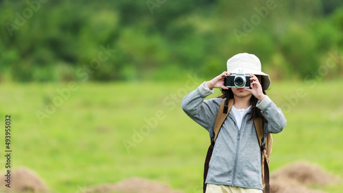 Asian girl woman take a photo and checking camera. People tourism travel destination leisure trips for education relax outdoors adventure forest nature, copy space for banner.