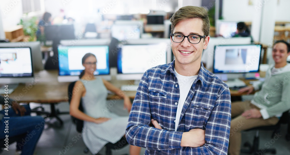 My team and I have got it all covered. Portrait of a smiling young designer standing in an office with colleagues working in the background. My team and I have got it all covered. Portrait of a smiling young designer standing in an office with colleagues working in the background.