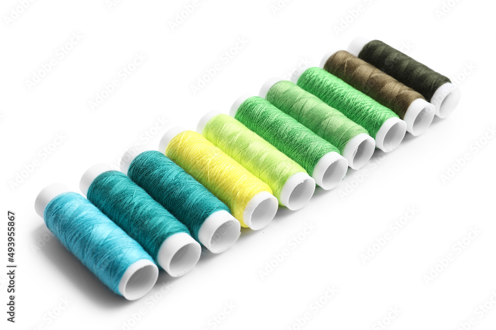 Multicolored sewing thread spools on white background Multicolored sewing thread spools on white background