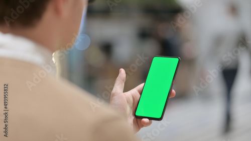 Young Man using Smartphone with Chroma Key Screen 